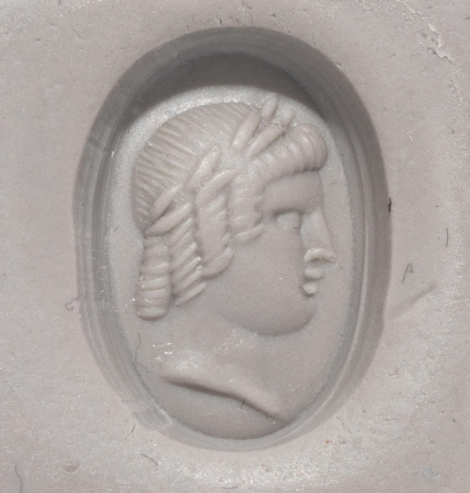A Roman Banded Agate Ring Stone with a Portrait Head of the God Apollo