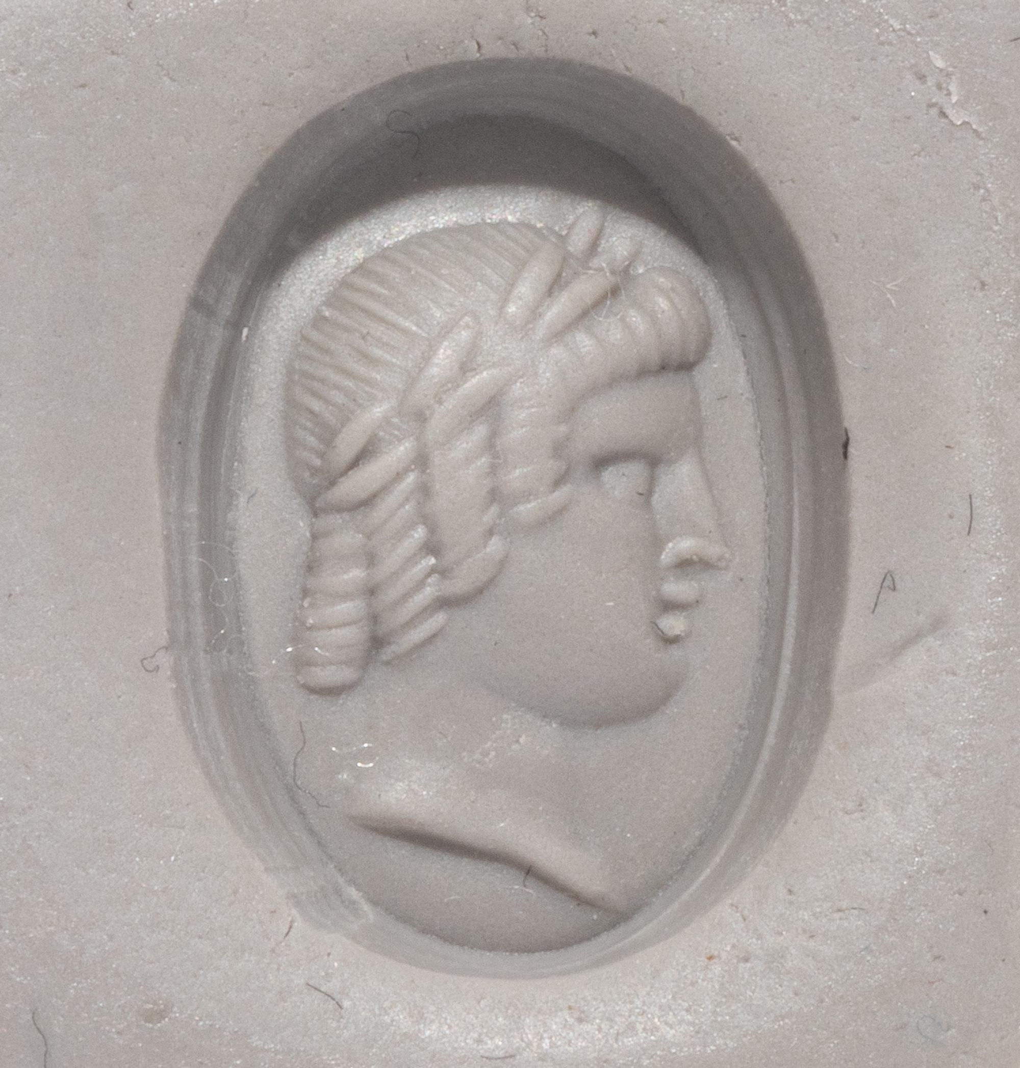 A Roman Banded Agate Ring Stone with a Portrait Head of the God Apollo