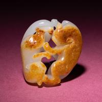 A Chinese Russet and Jade 'Double Badger' Pendant, 18th/19th Century — 清中期 白玉帶皮如意雙歡佩