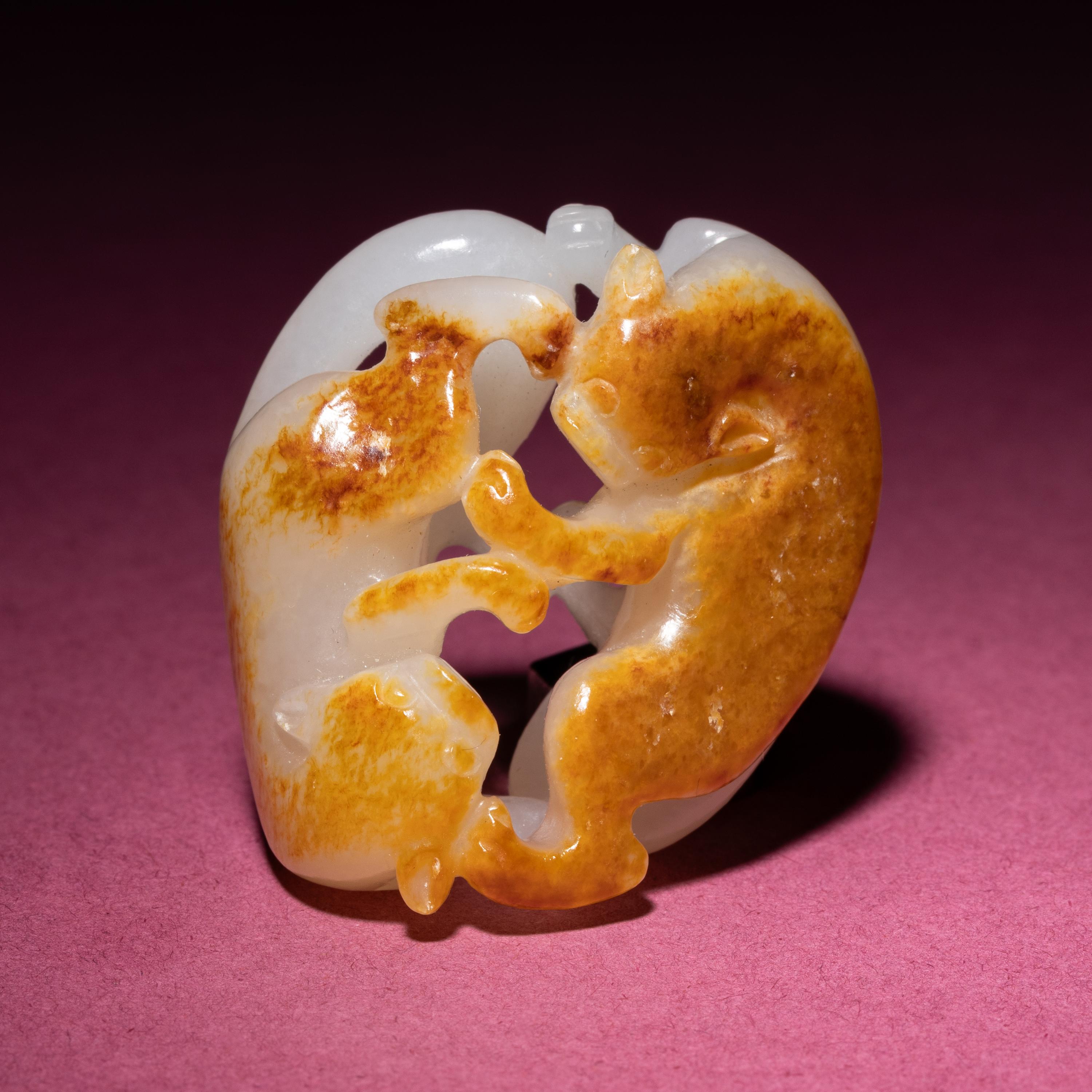 A Chinese Russet and Jade 'Double Badger' Pendant, 18th/19th Century — 清中期 白玉帶皮如意雙歡佩