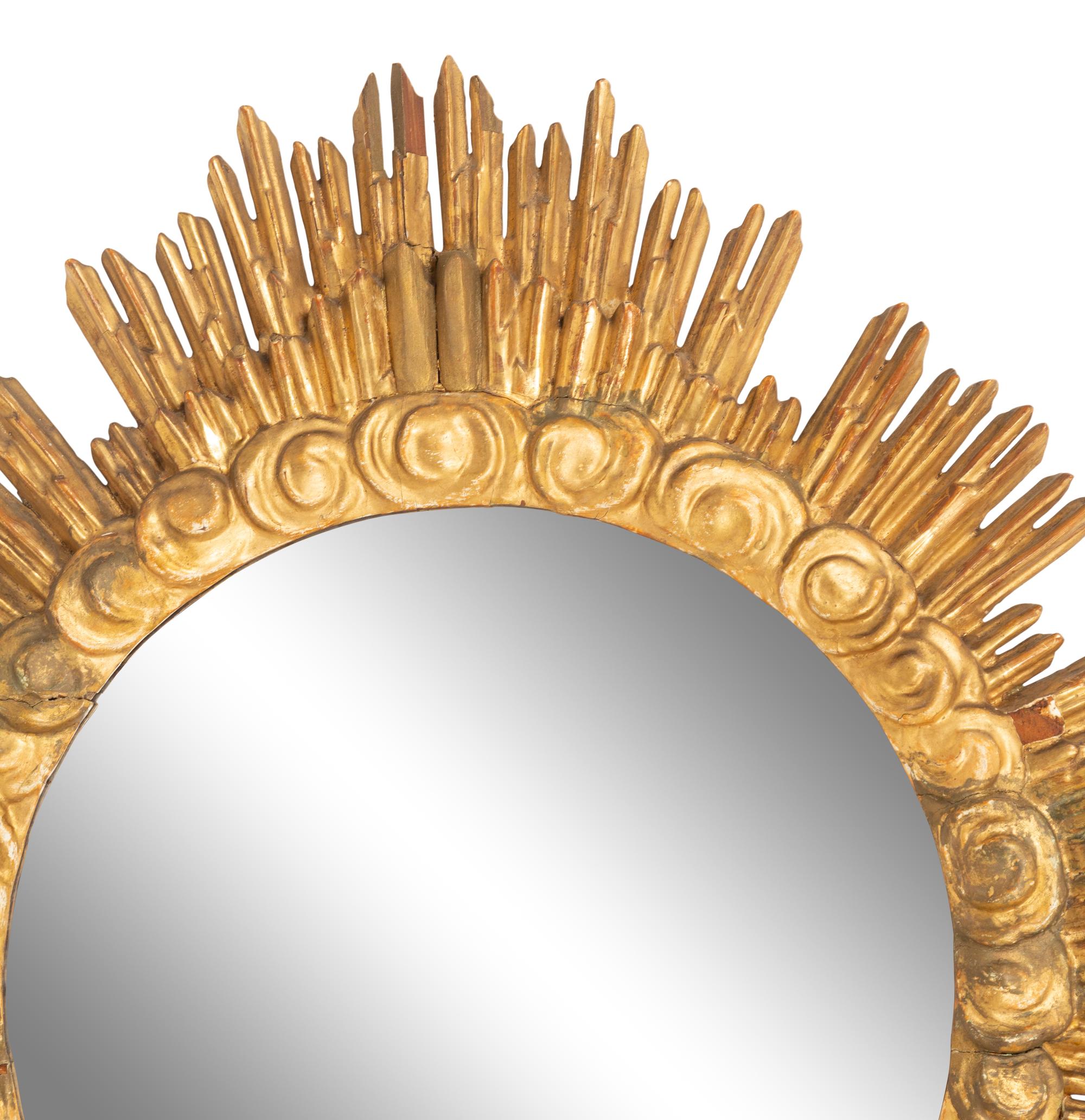 An Italian Carved Giltwood Sunburst and Cloud Framed Mirror