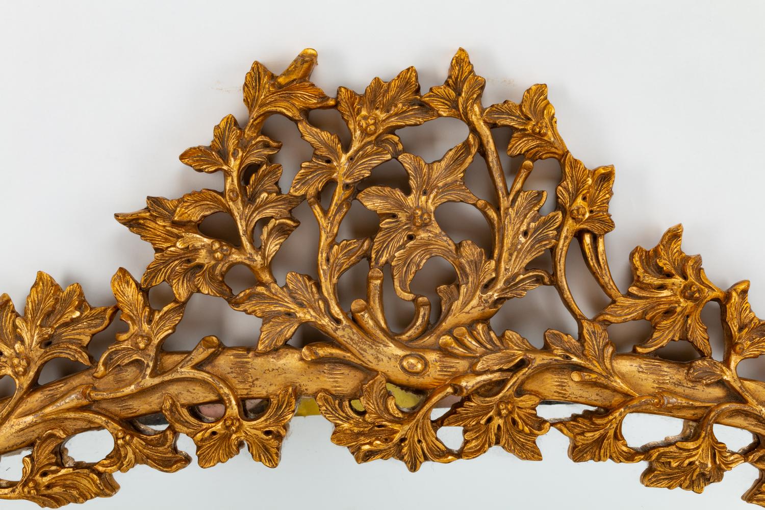 An Italian Rococo Style Carved Giltwood Oval Mirror