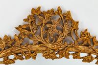 An Italian Rococo Style Carved Giltwood Oval Mirror