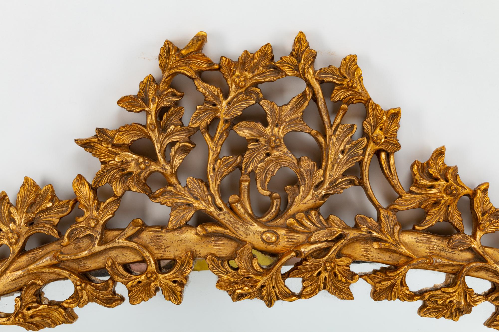 An Italian Rococo Style Carved Giltwood Oval Mirror