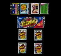 A Collection of 1980s Unopened Topps Football Card Packs Including John Elway Rookie
