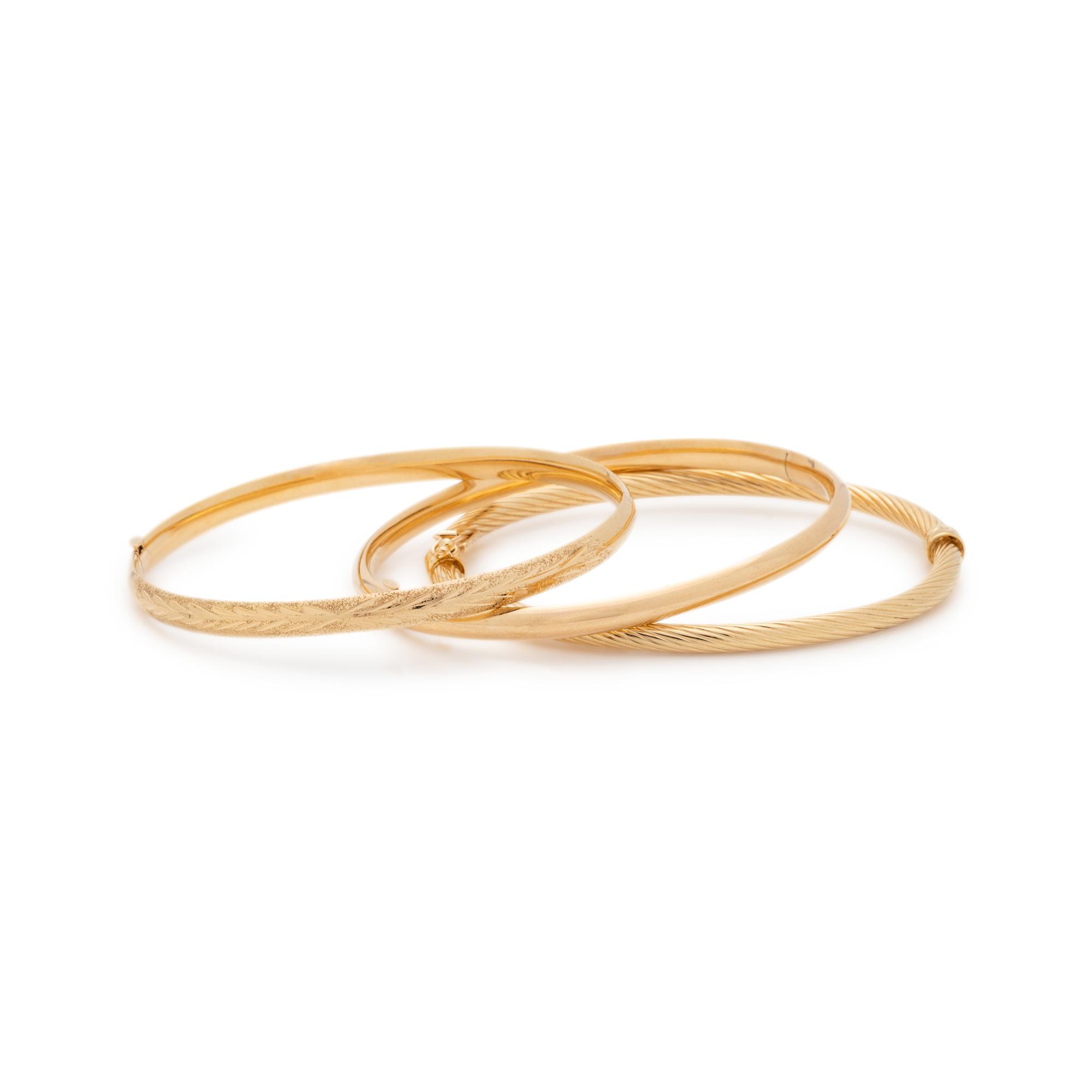 COLLECTION OF YELLOW GOLD BANGLE BRACELETS