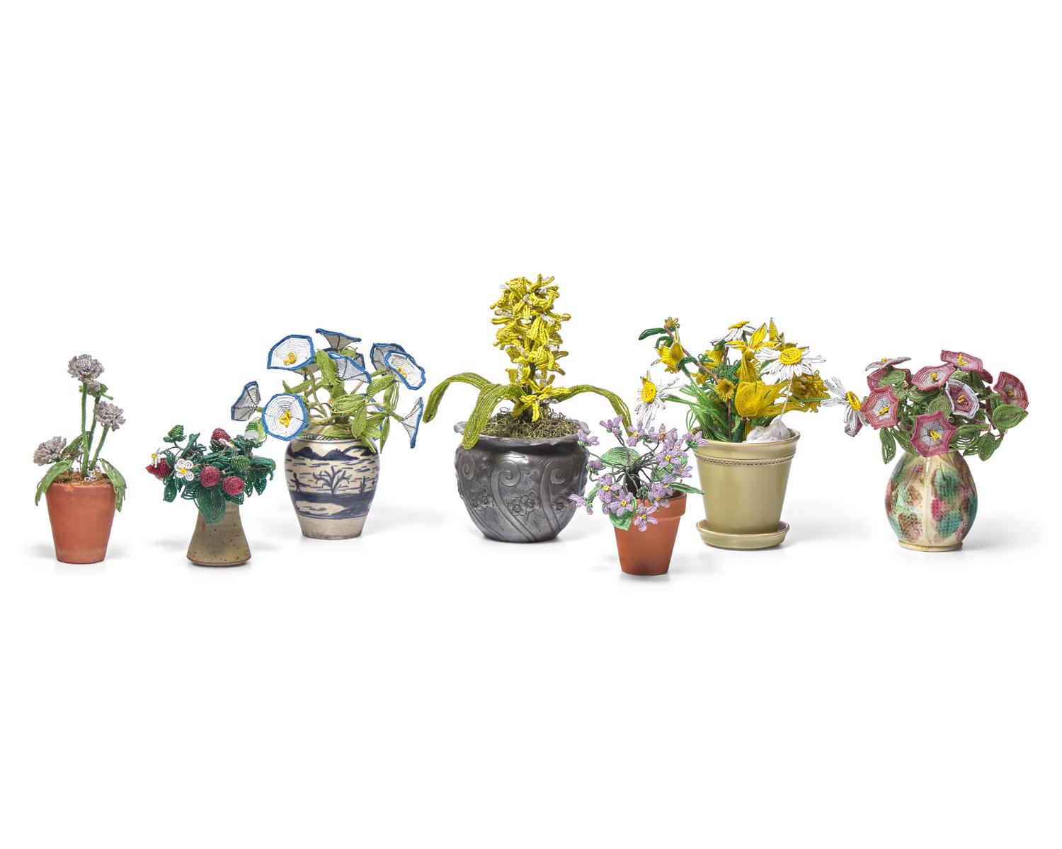 A Collection of Twenty-One French Beaded and Glass Flower and Fruit Arrangements