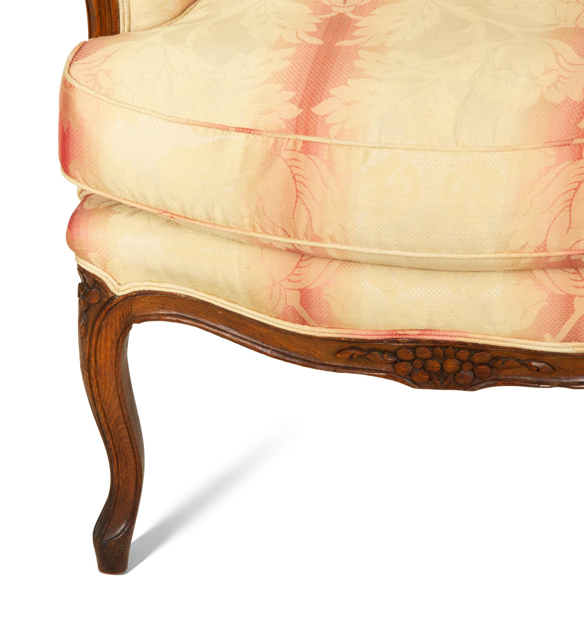 A Pair of Louis XV Style Walnut Bergères