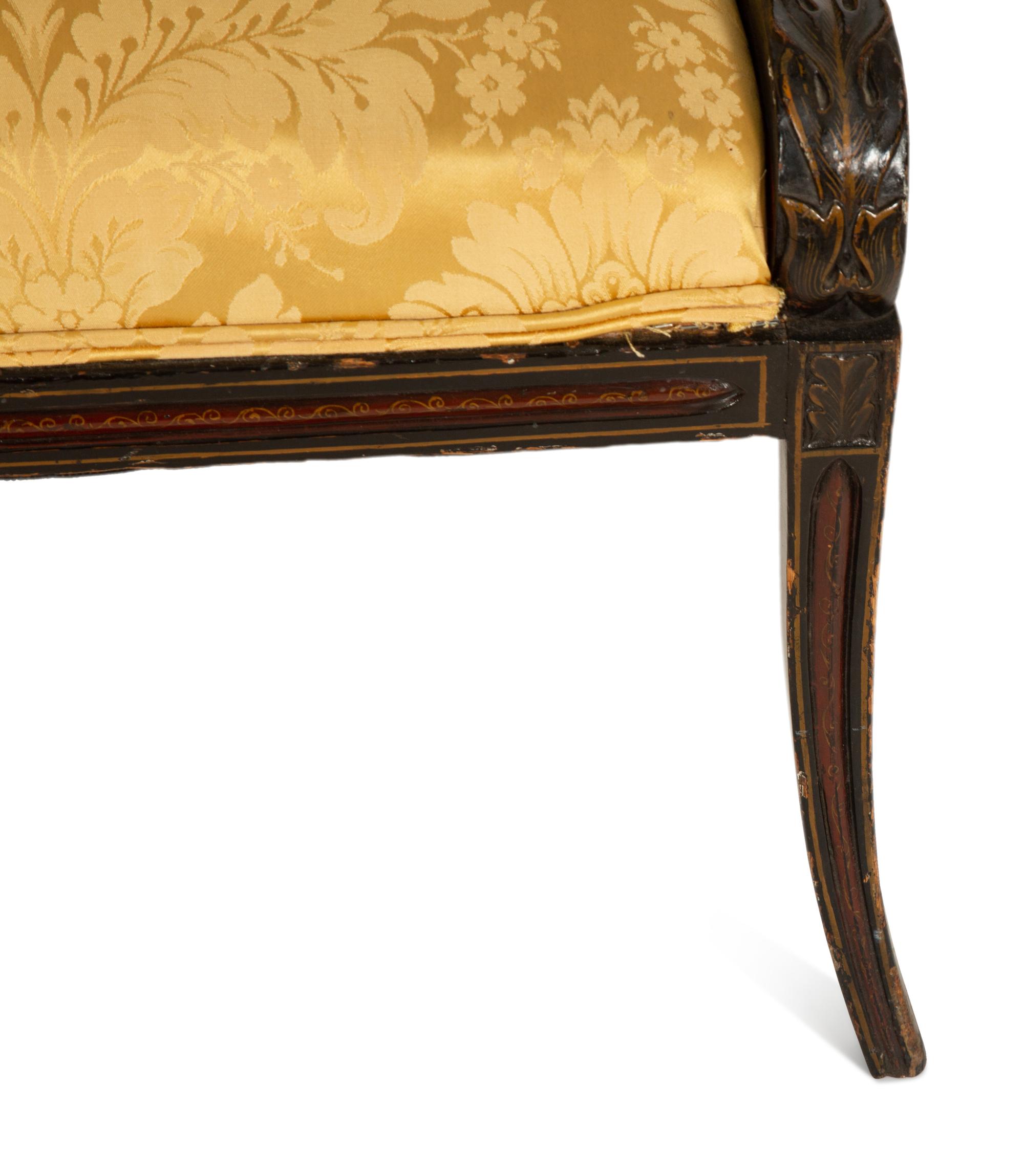 A Pair of Regency Ebonized and Gilt Barrel Back Armchairs