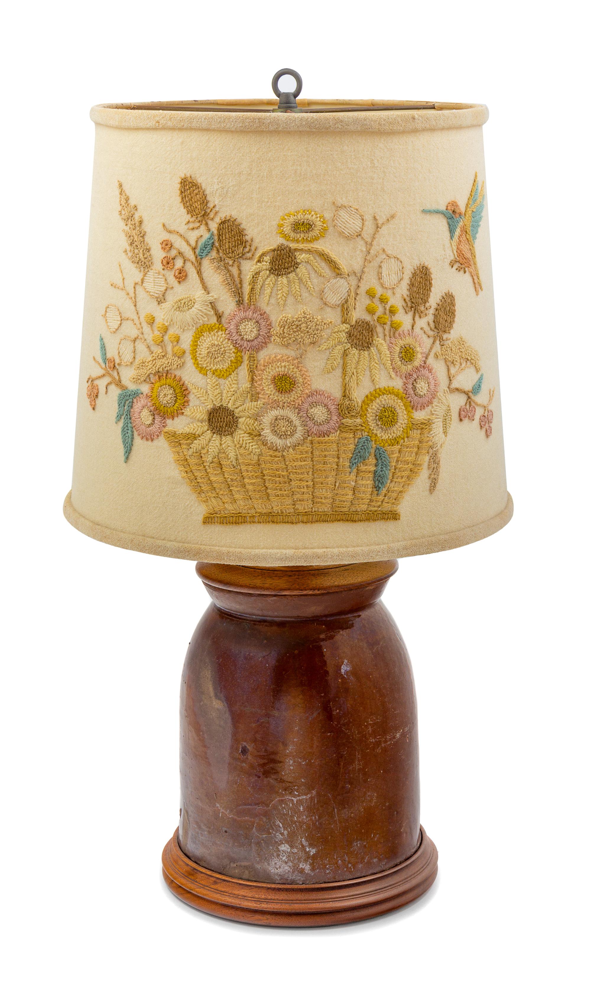 A Brown Glazed Stoneware Crock with a Later Crewel Work Shade