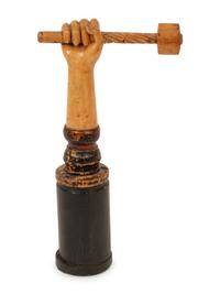 A Folk Art Carved and Polychrome Painted Hand Clutching a Hammer