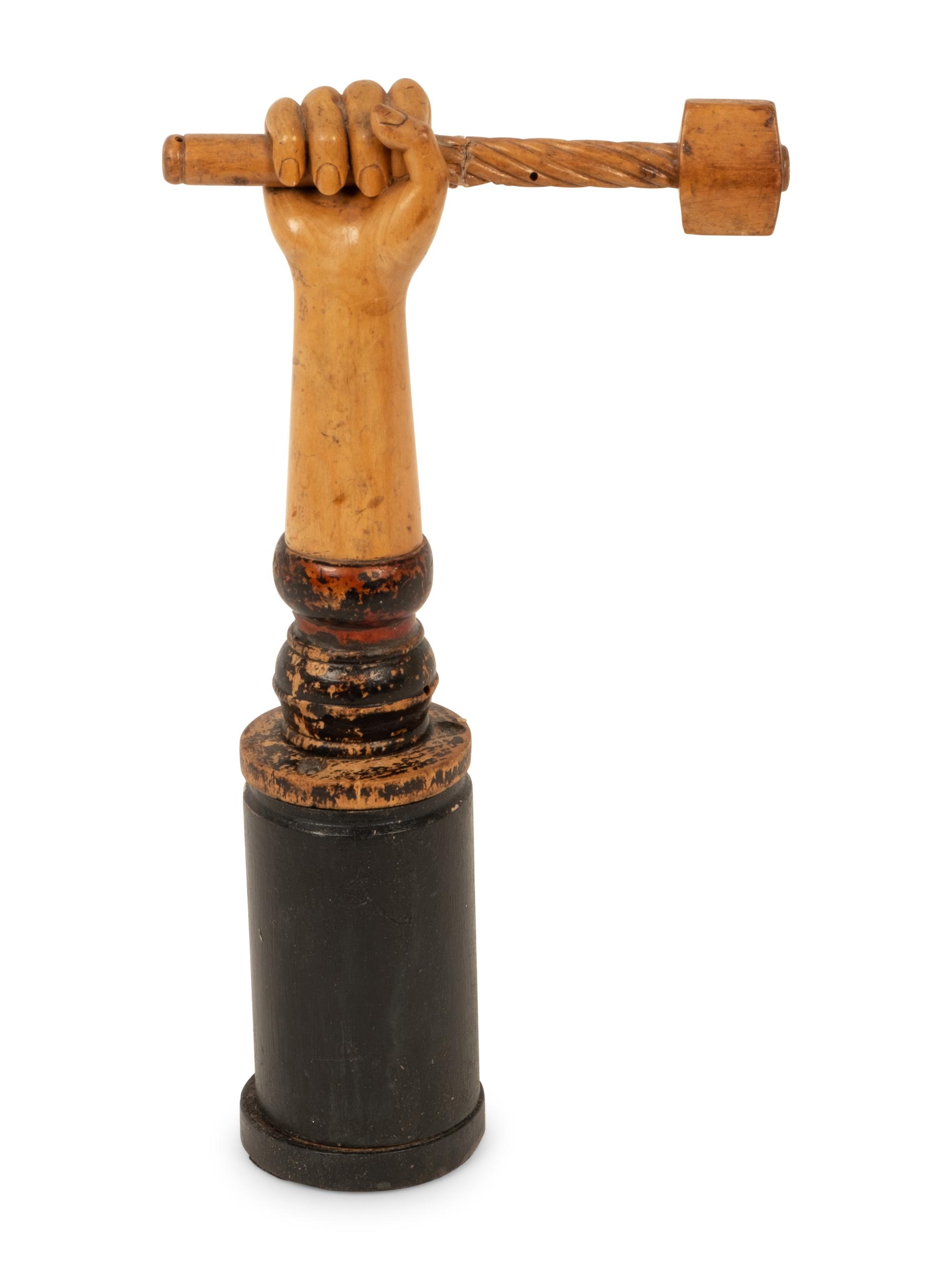 A Folk Art Carved and Polychrome Painted Hand Clutching a Hammer
