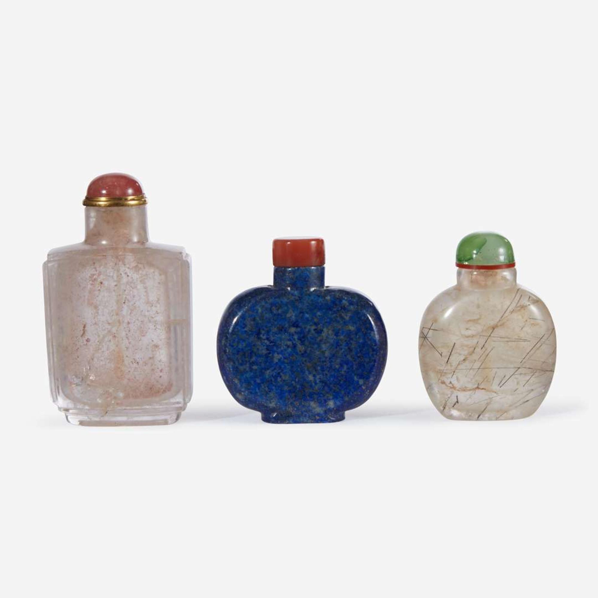 Two Chinese rock crystal snuff bottles and one lapis lazuli snuff bottle