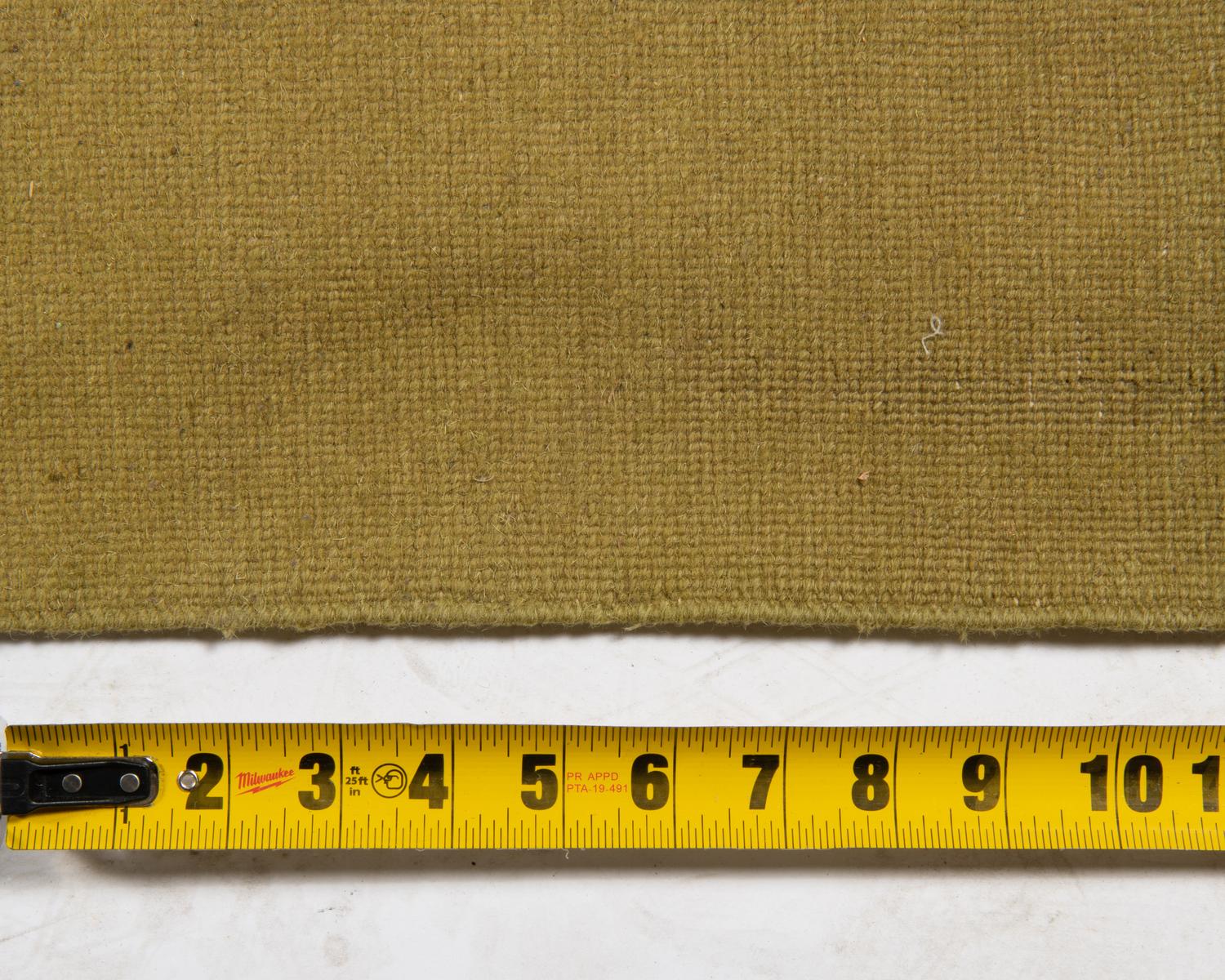 A Two-Tone Green Wool Area Rug
