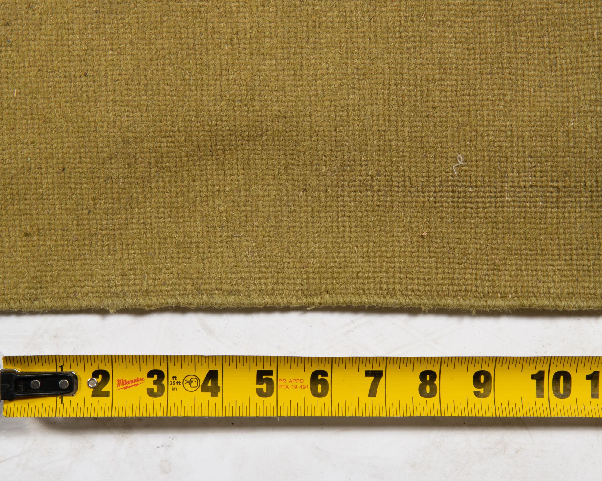 A Two-Tone Green Wool Area Rug