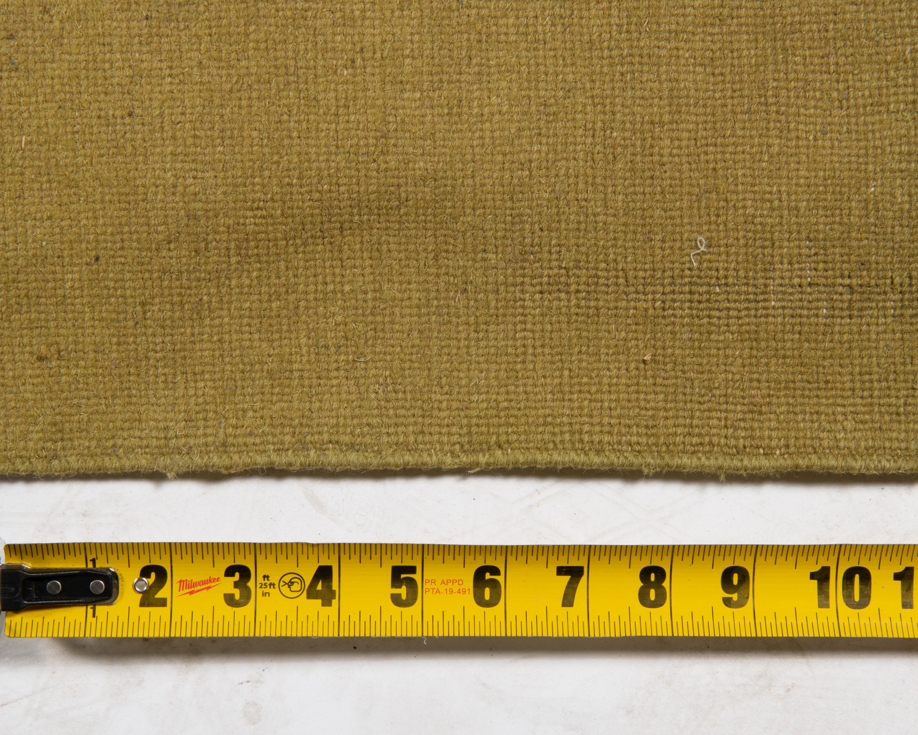 A Two-Tone Green Wool Area Rug