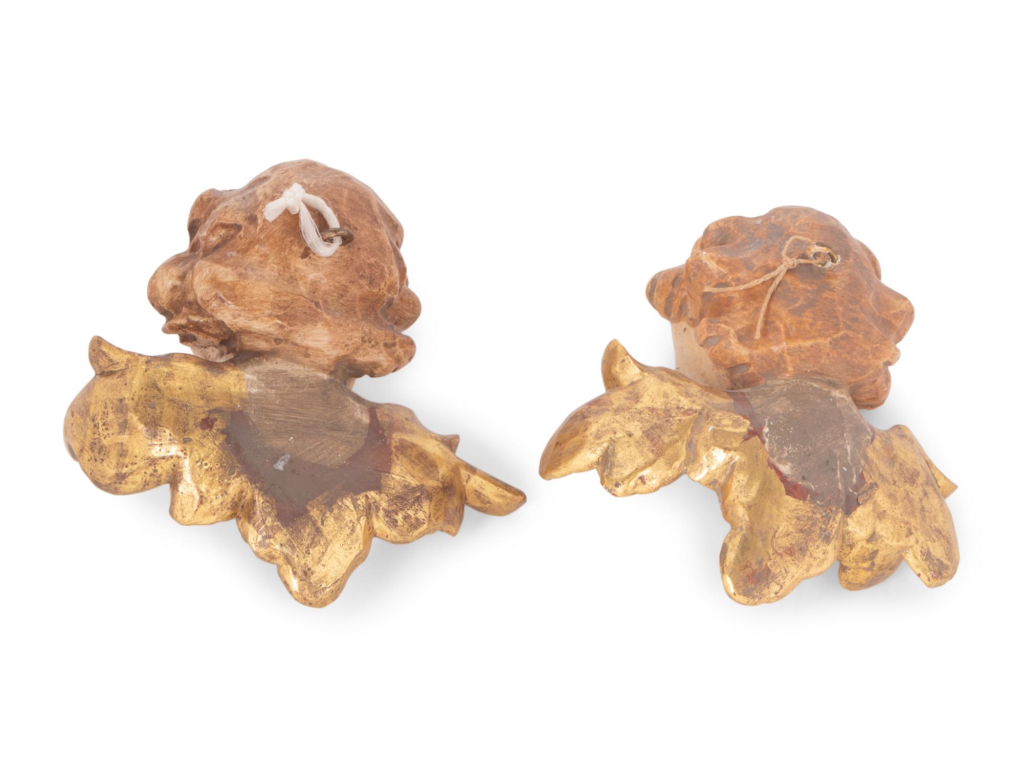 A Pair of Continental Painted and Parcel Gilt Putto Masks