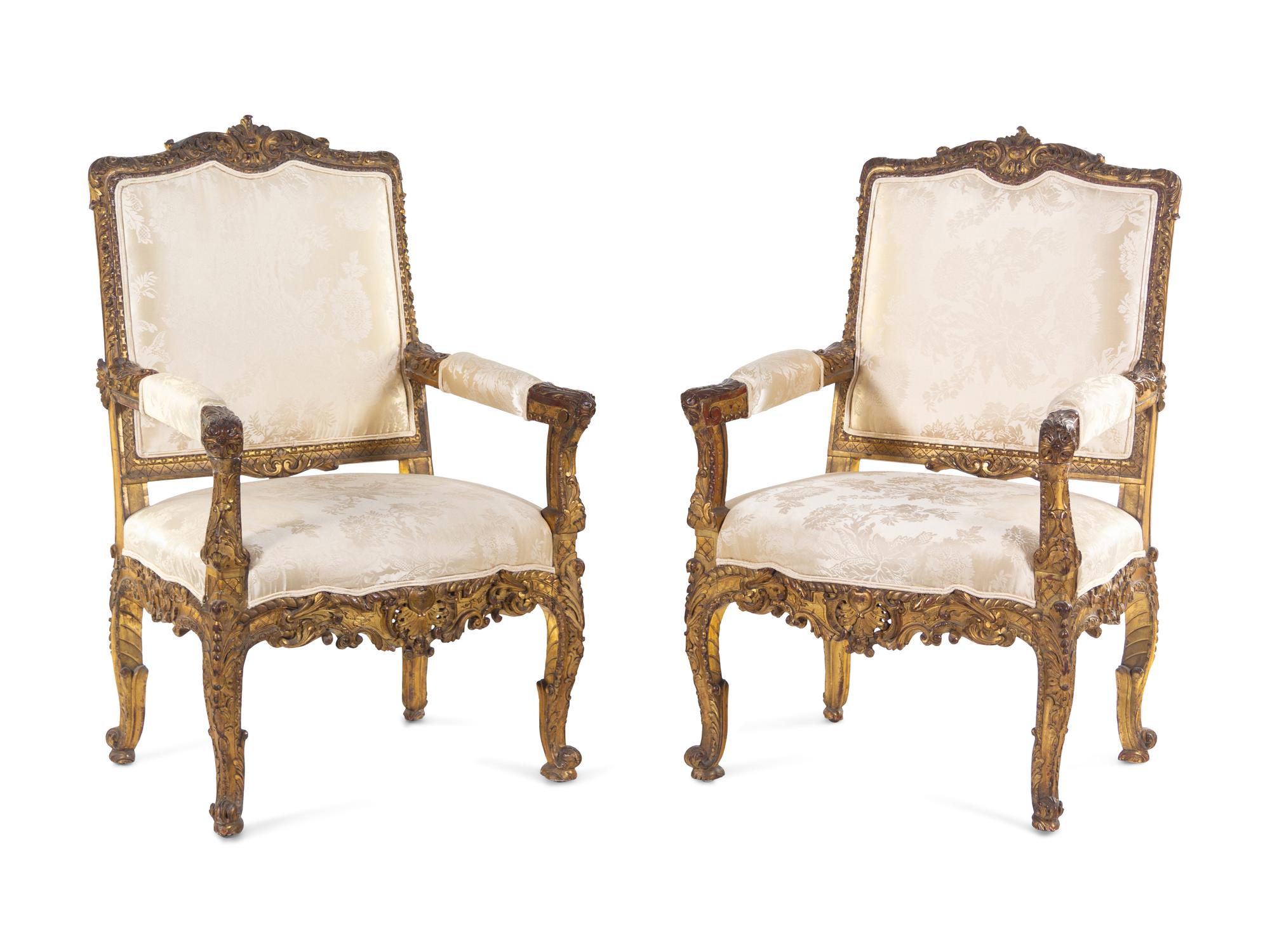 A Pair of Régence Style Carved Giltwood Fauteuils