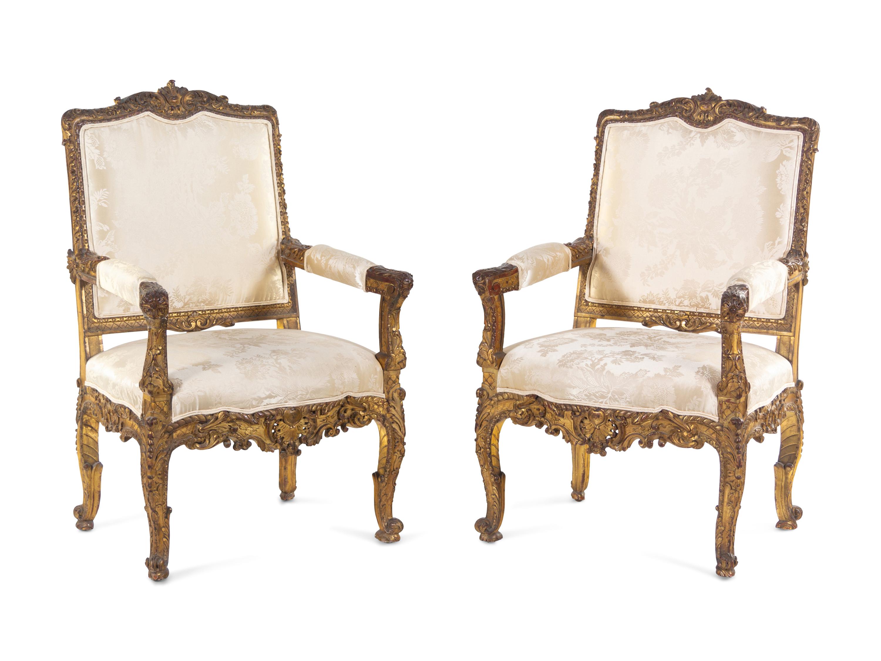 A Pair of Régence Style Carved Giltwood Fauteuils