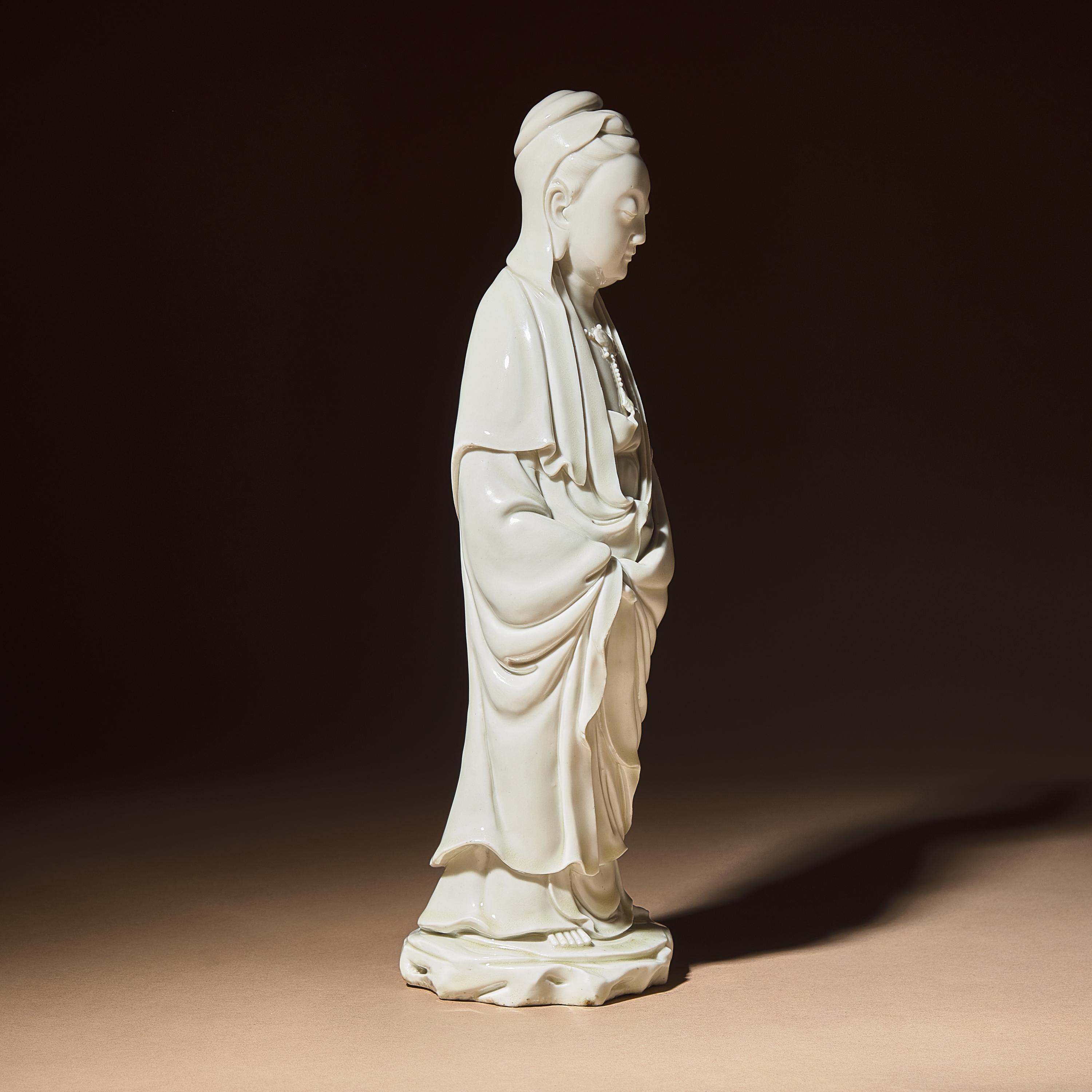 A Chinese Blanc-de-Chine Porcelain Standing Figure of Guanyin with 'He Chaozong' Mark, Qing Dynasty — 清 何朝宗款德化白瓷觀音立像