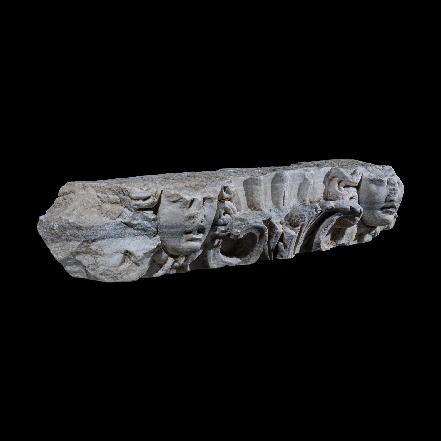 A Roman Marble Frieze Fragment with Heads of Medusa