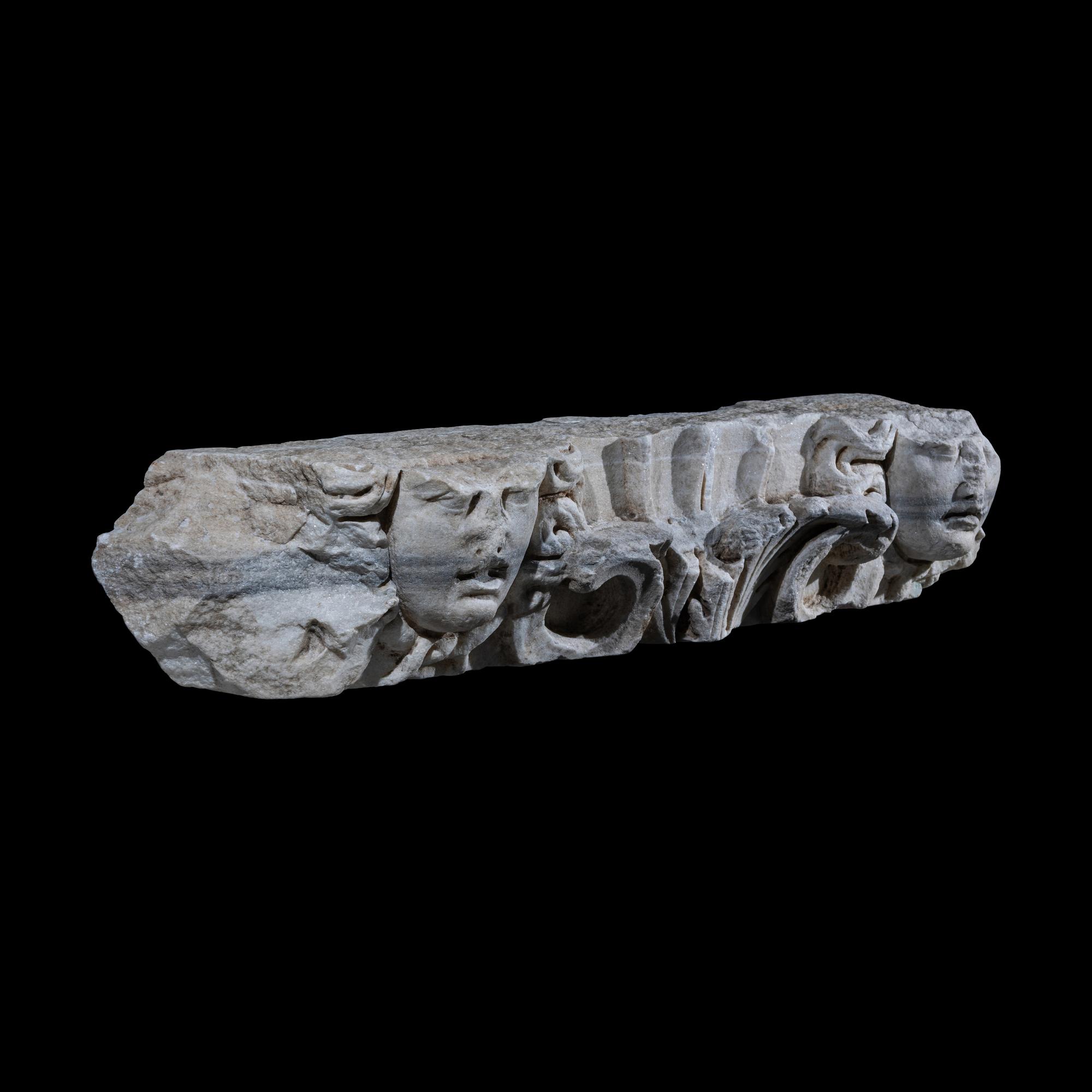 A Roman Marble Frieze Fragment with Heads of Medusa
