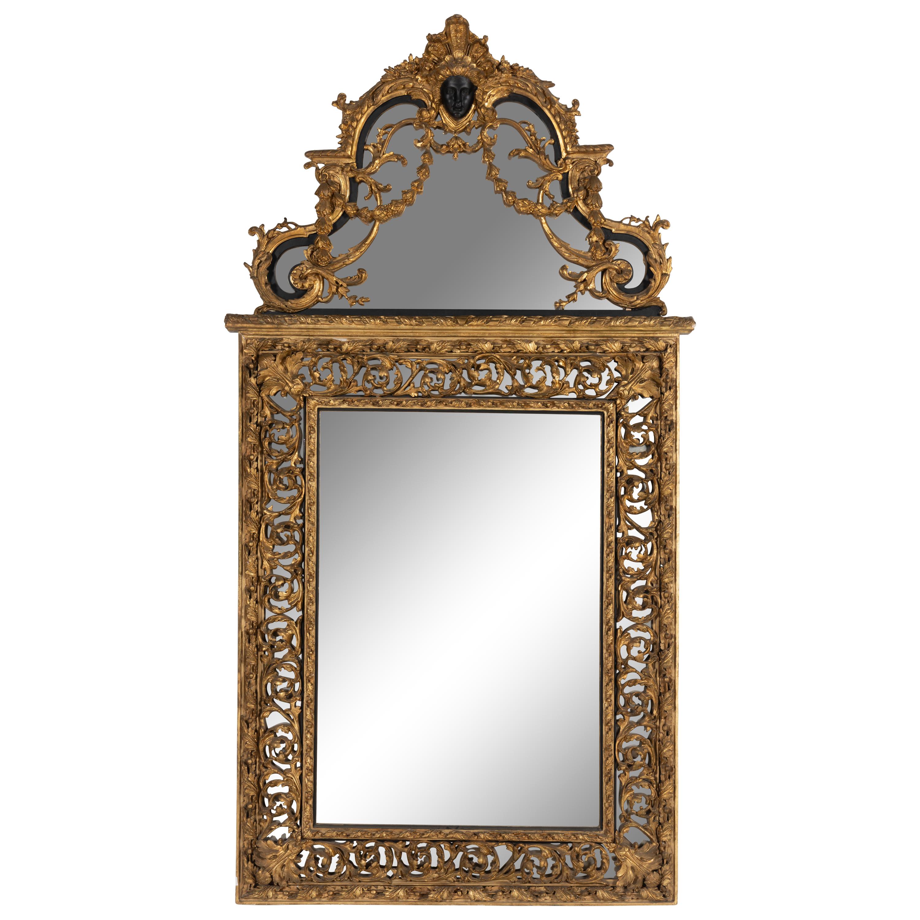 A Baroque Style Part Ebonized Giltwood and Gesso Mirror