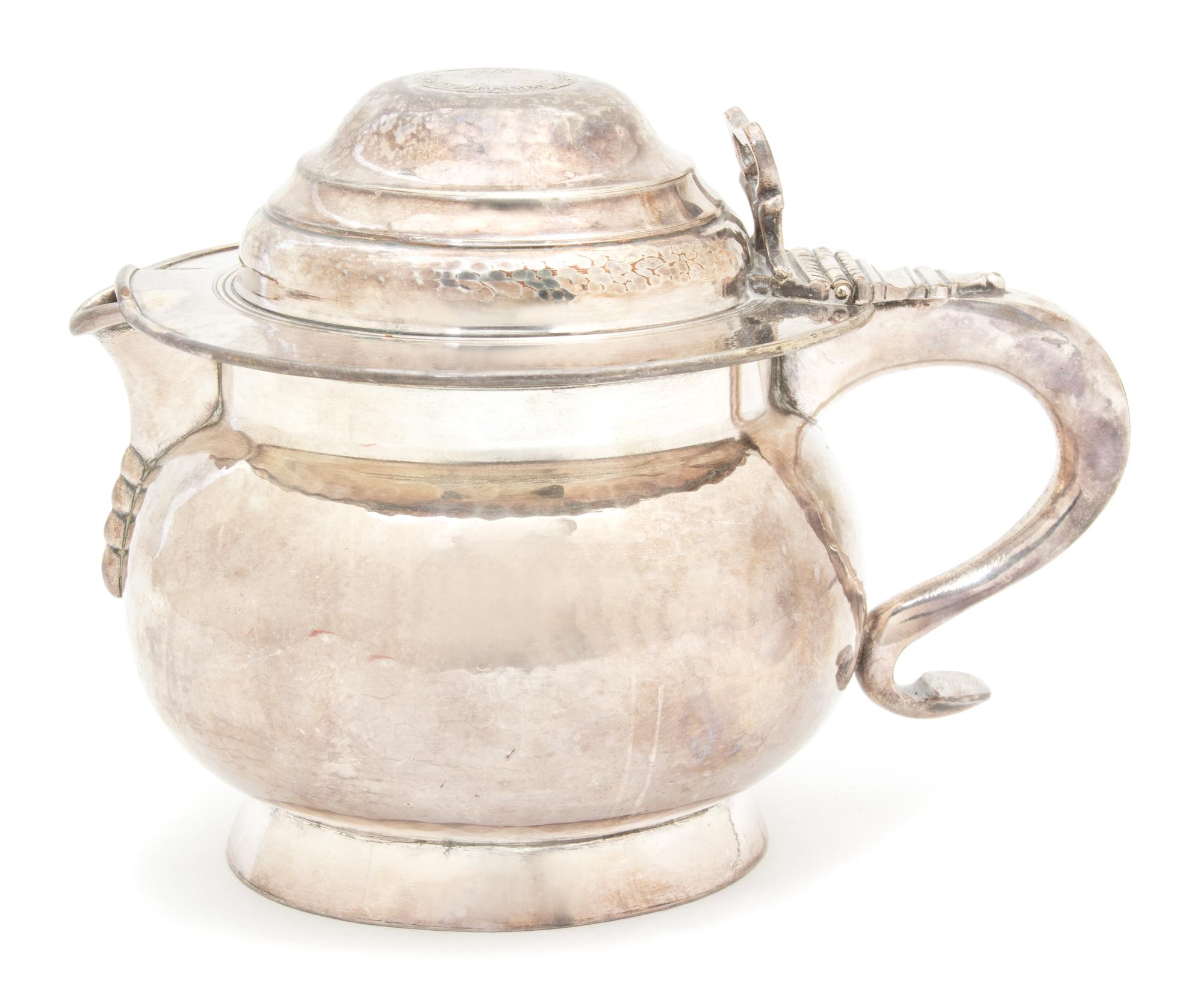 A Irish Silver Plate Hand Hammered Pitcher, 19TH CENTURY, the lid inset with an Irish coin, with an engraved armorial on the body.