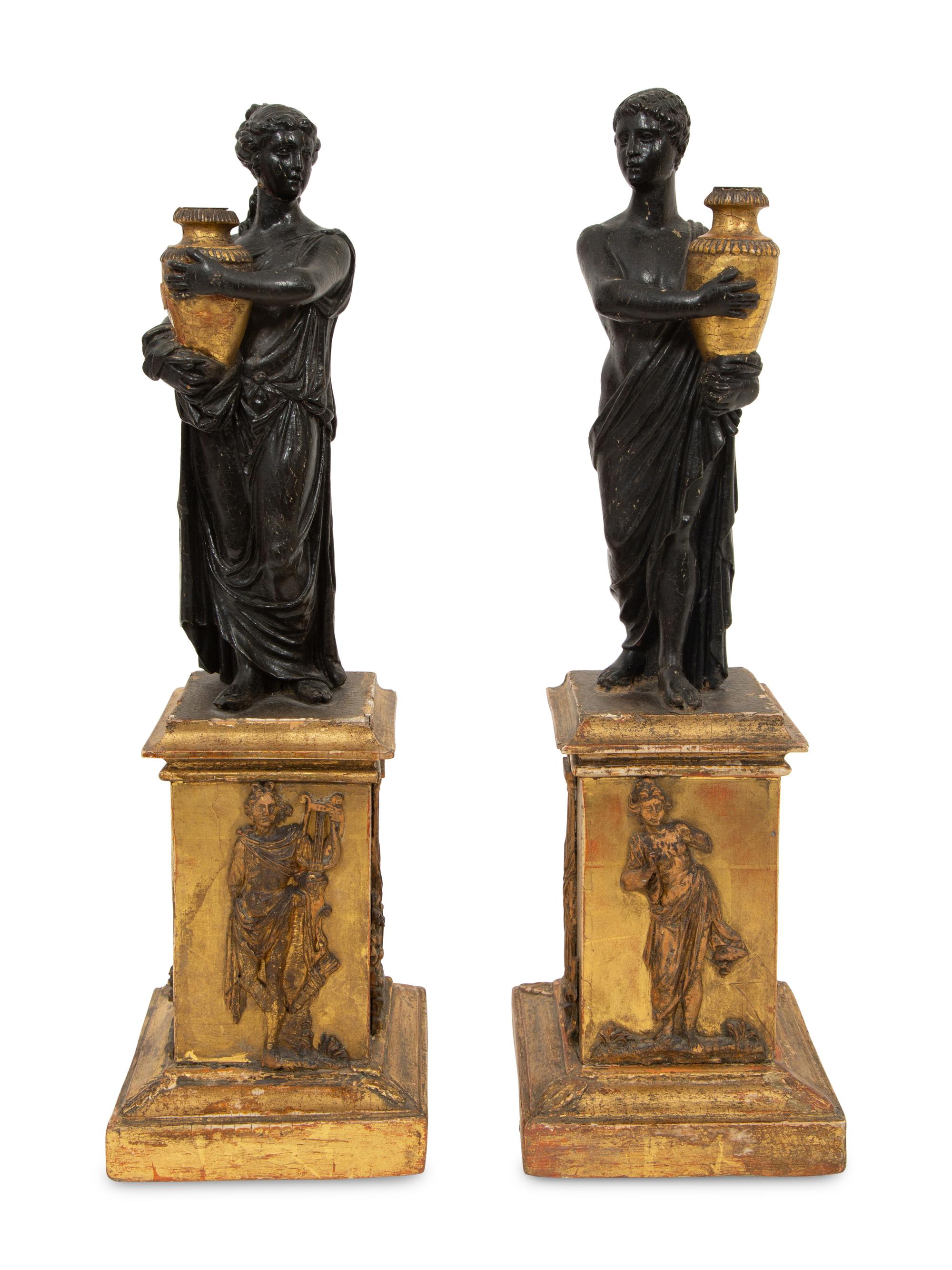 A Pair of Continental Carved, Parcel Ebonized and Gilt Wood Neoclassical Figures