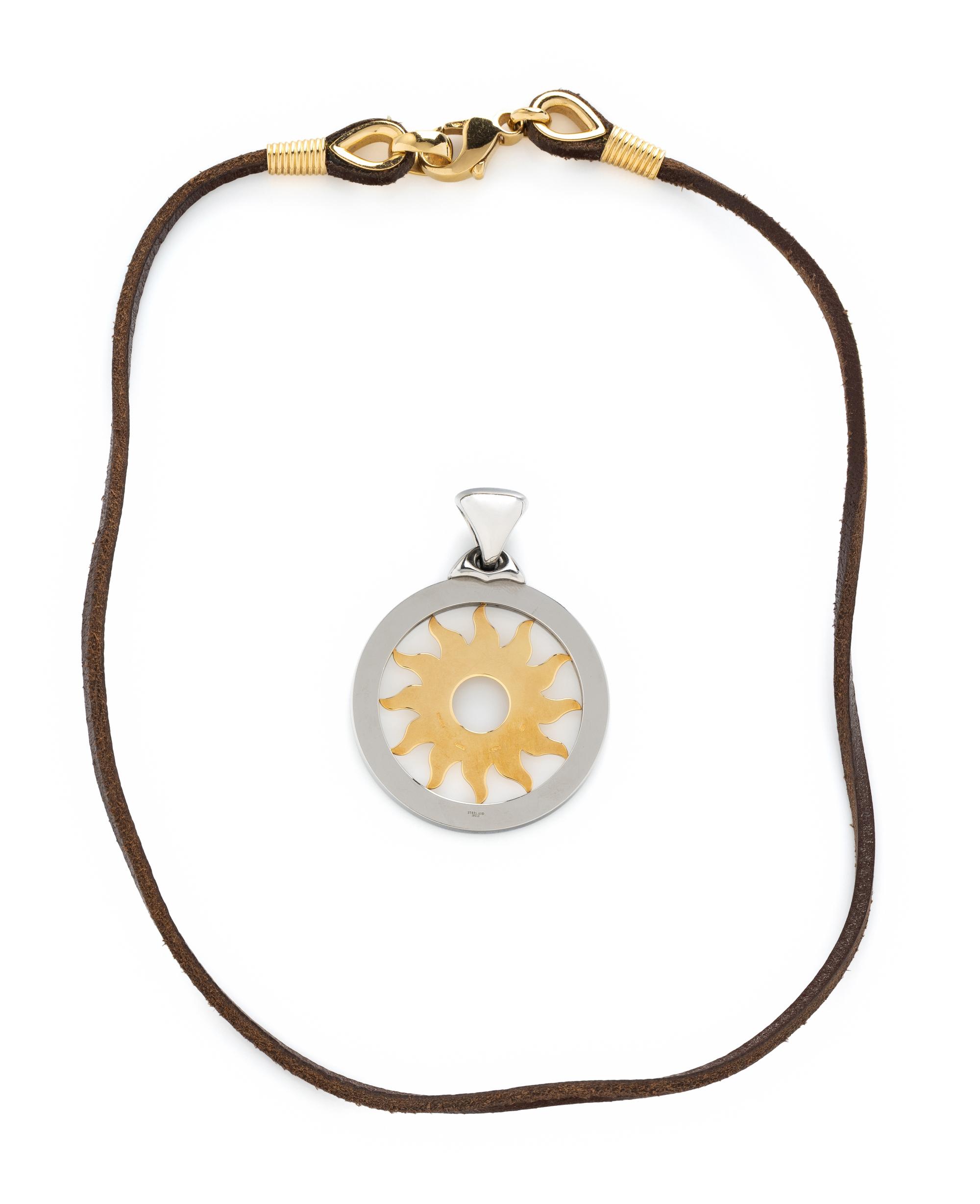 BULGARI, YELLOW GOLD AND STEEL SUN PENDANT AND BROWN LEATHER CORD