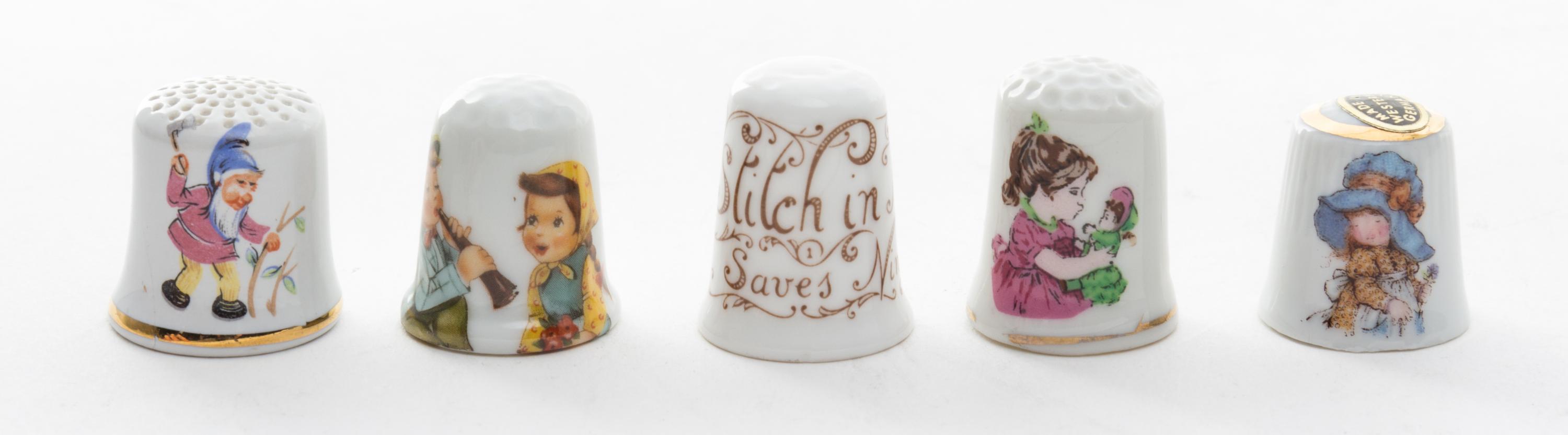 A Group of Porcelain Thimbles Height of first 7/8 inch.
