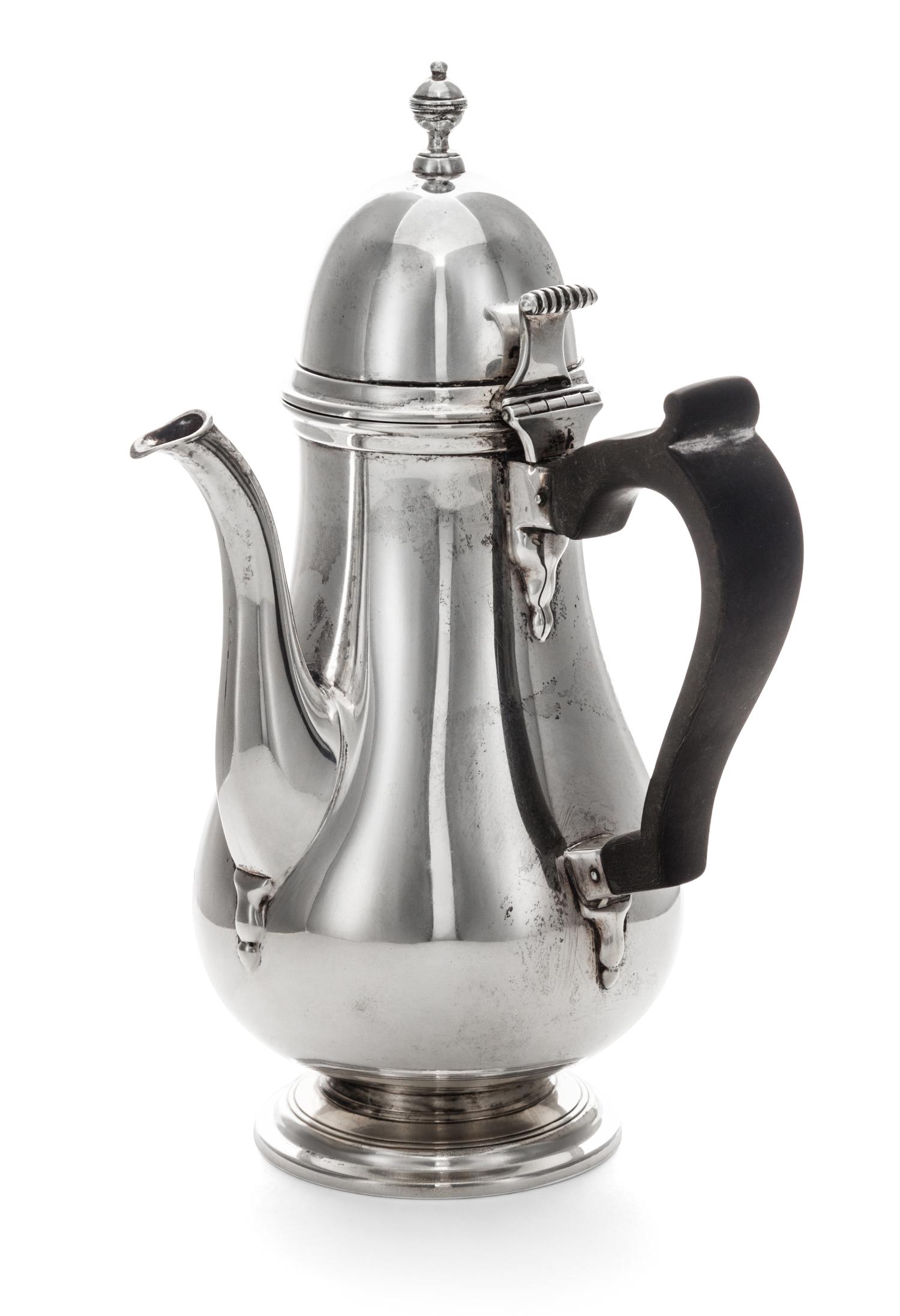 An American Silver Chocolate Pot, Tuttle Silversmiths, Boston, MA, of baluster form with a wood handle and a circular foot.