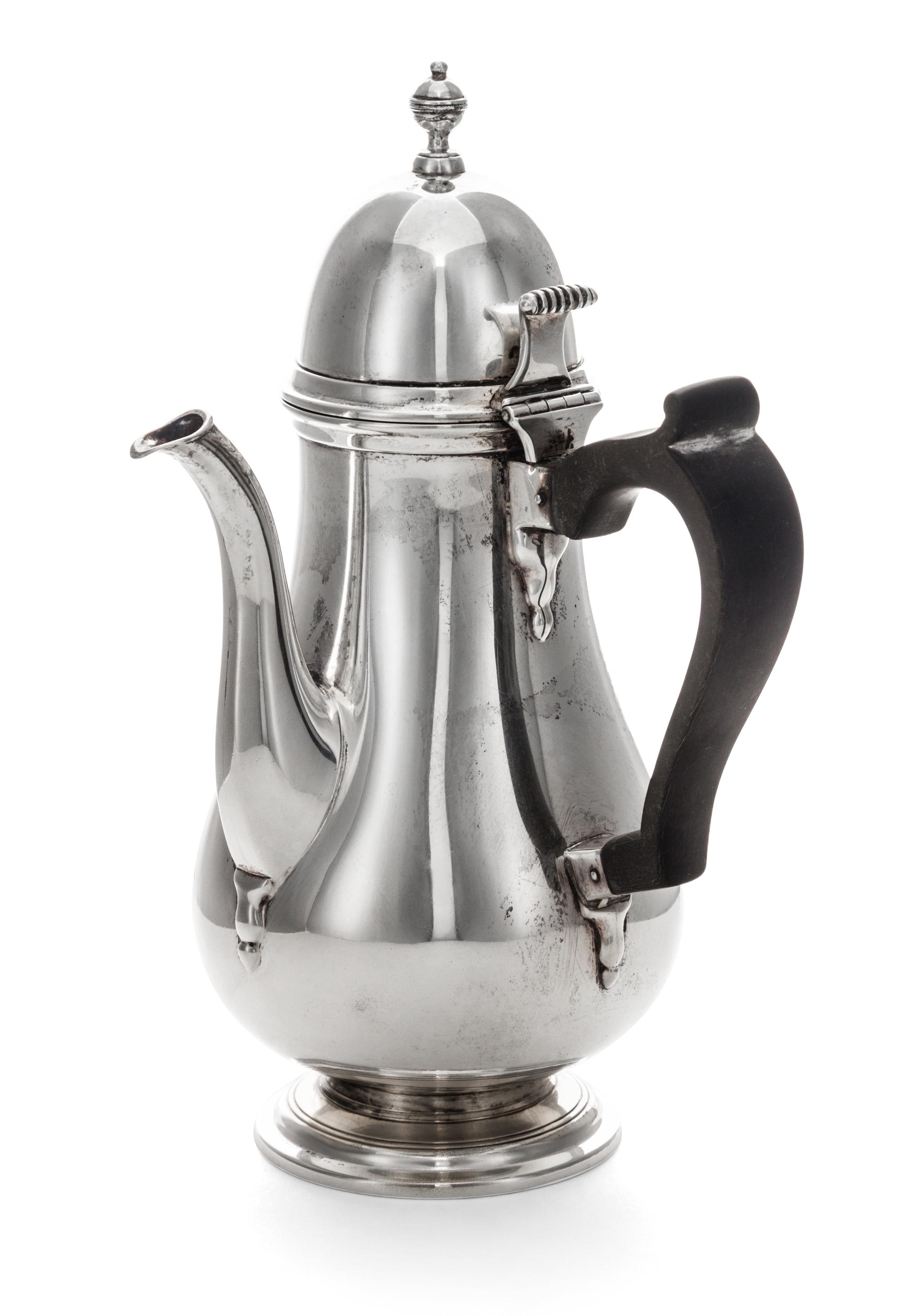 An American Silver Chocolate Pot, Tuttle Silversmiths, Boston, MA, of baluster form with a wood handle and a circular foot.
