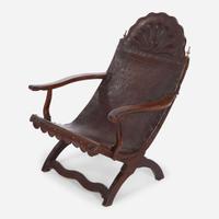 A carved mahogany and tooled leather Campeche chair Mexico, late 18th / early 19th century