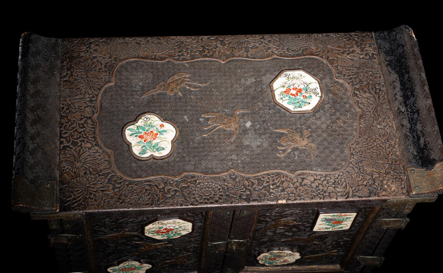 A Japanese Porcelain and Metal Inset Wood Chest