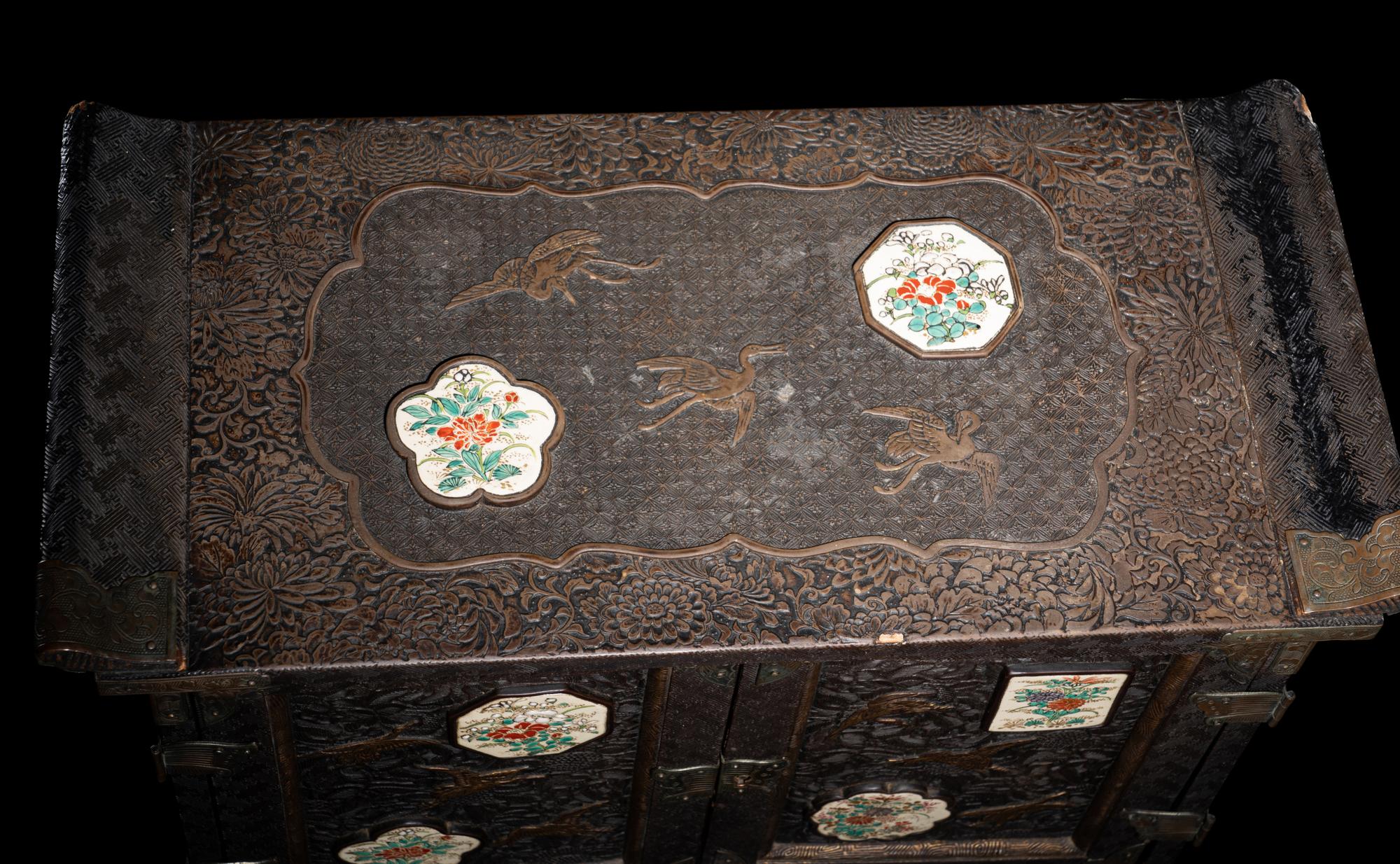 A Japanese Porcelain and Metal Inset Wood Chest