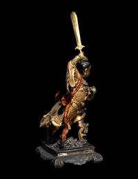 A Gilt and Lacquered Wood Figure of a Guardian