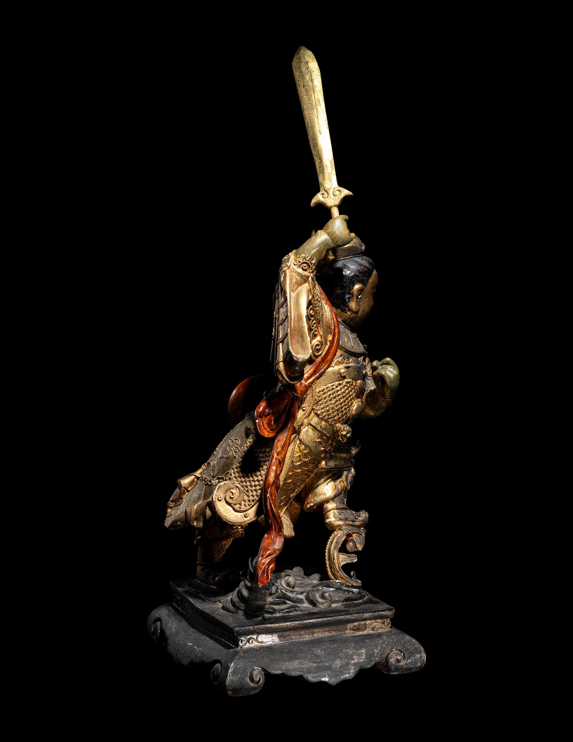 A Gilt and Lacquered Wood Figure of a Guardian