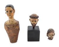 A Carved and Polychrome Painted Santos Heads