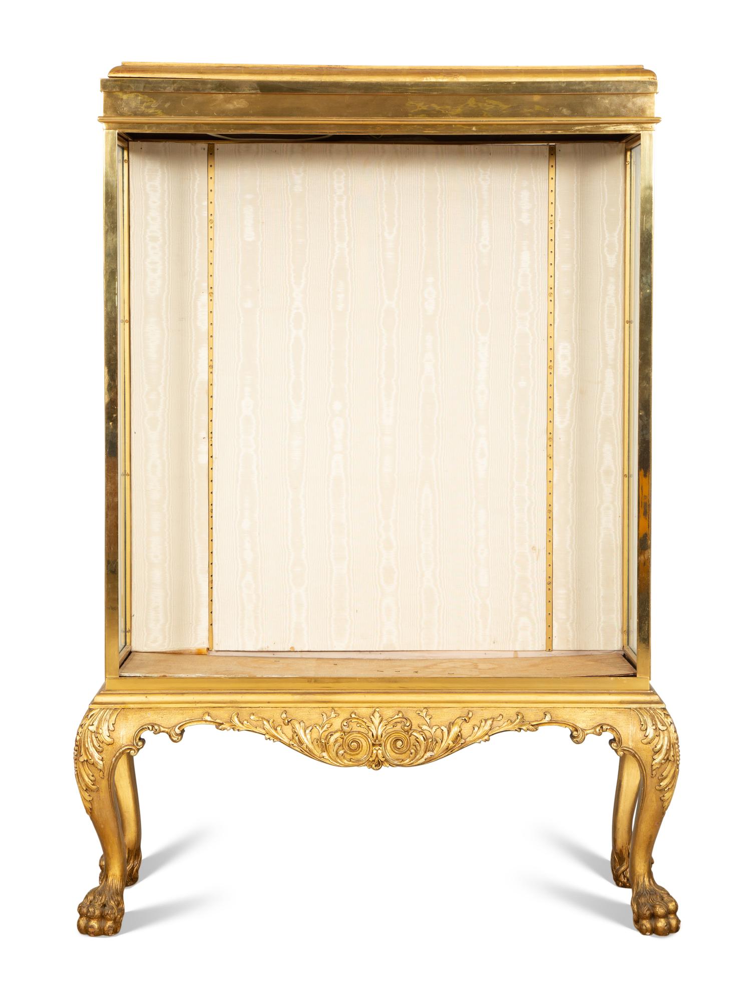 An English Brass Vitrine Cabinet on a Giltwood Base