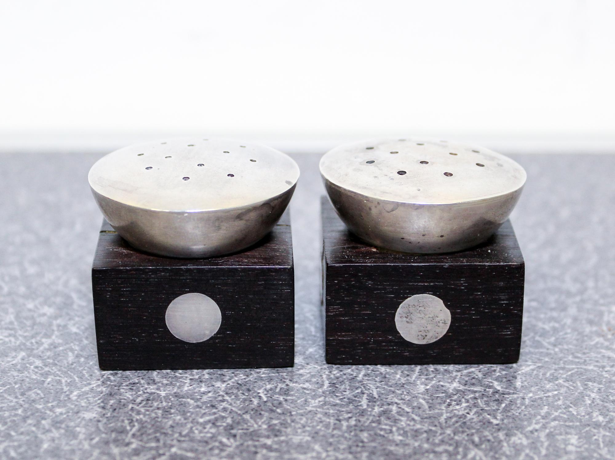 A Pair of Mexican Silver and Rosewood Castors, William Spratling, Taxco, the square ebony base with inset silver discs with a pierced s