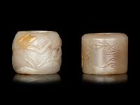 Two Carved Celadon Jade Archer's Rings