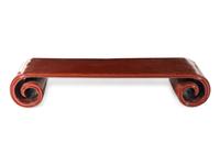 A Chinese Red Lacquered Low Scrolled-Form Low Table, Qinzhuo