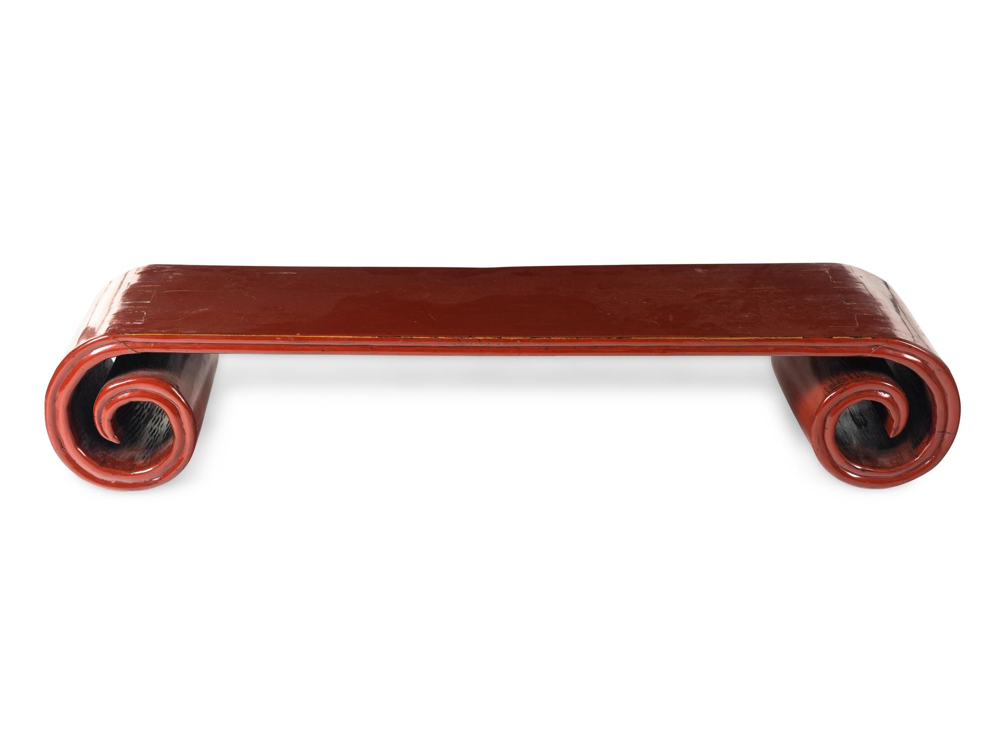 A Chinese Red Lacquered Low Scrolled-Form Low Table, Qinzhuo