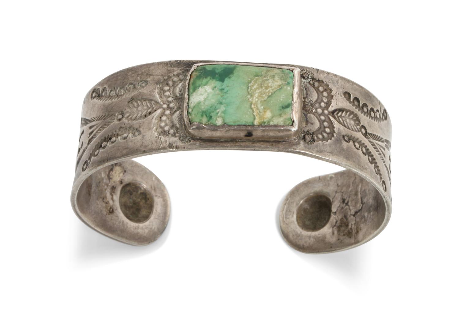 A Navajo Stamped Turquoise and Silver Bracelet Length 5 5/8 x opening 7/8 x width 3/4 inches.