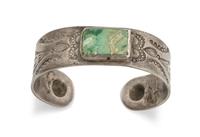 A Navajo Stamped Turquoise and Silver Bracelet Length 5 5/8 x opening 7/8 x width 3/4 inches.