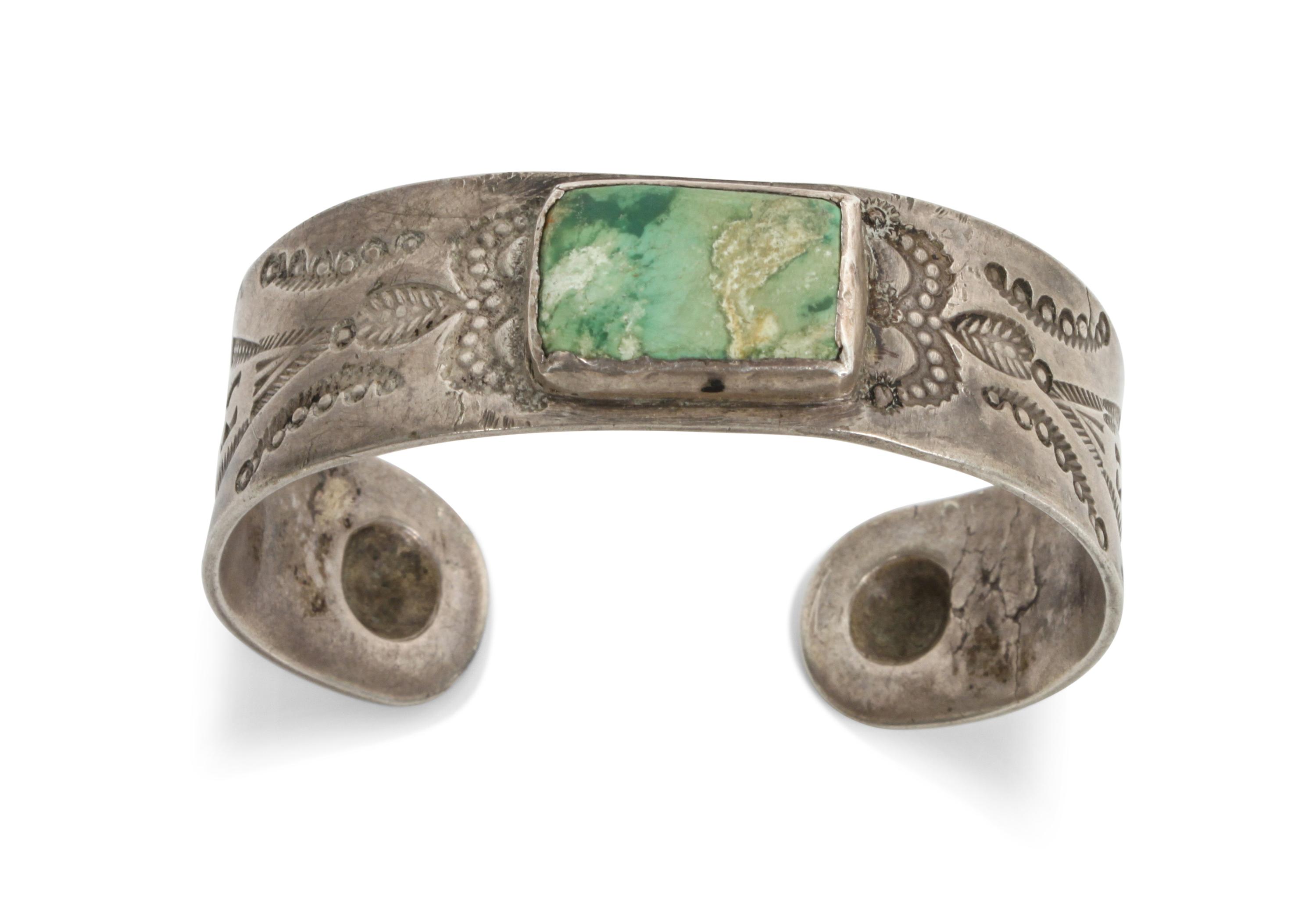 A Navajo Stamped Turquoise and Silver Bracelet Length 5 5/8 x opening 7/8 x width 3/4 inches.