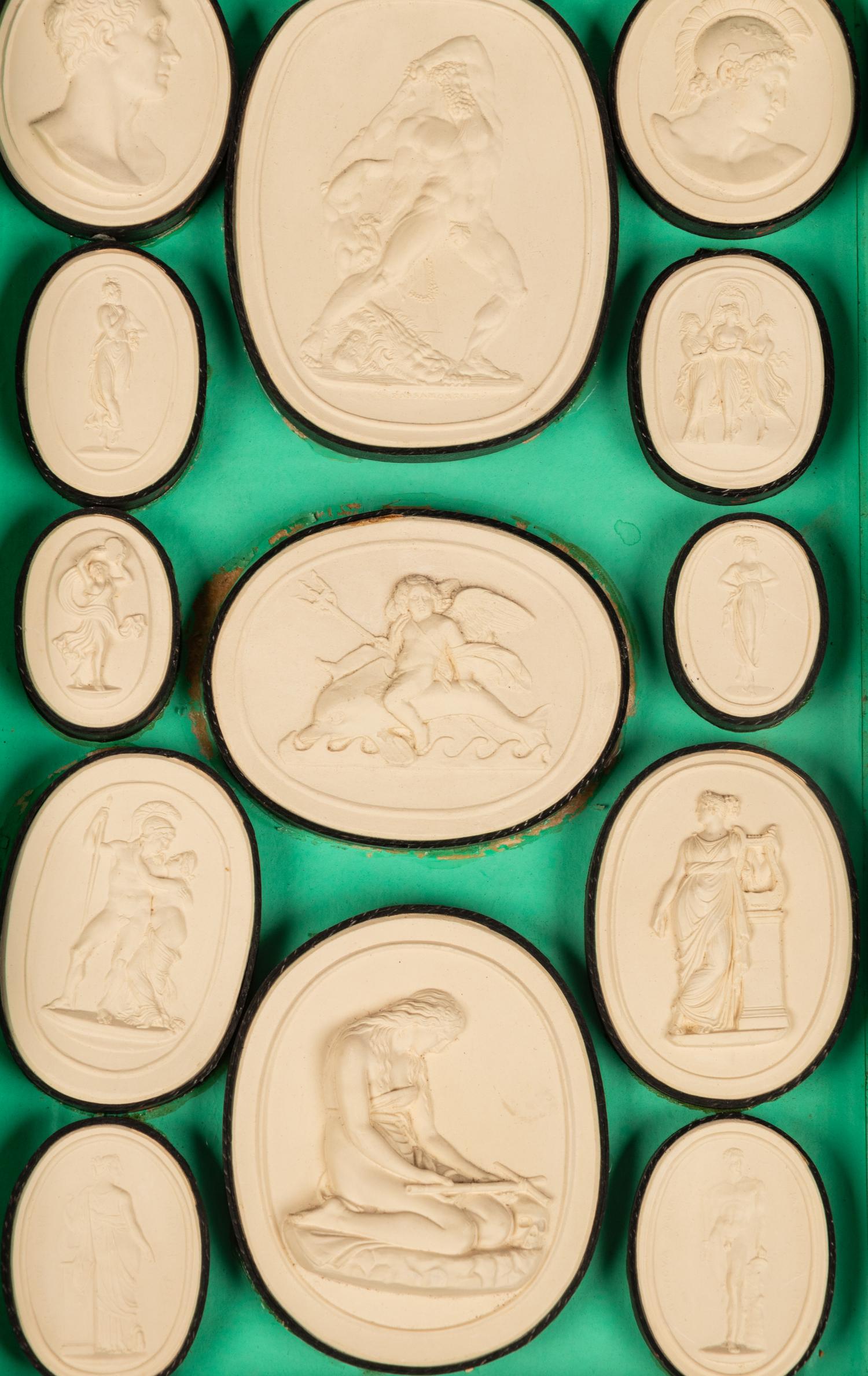 A Collection of Grand Tour Plaster Intaglios in Book-Form Cases