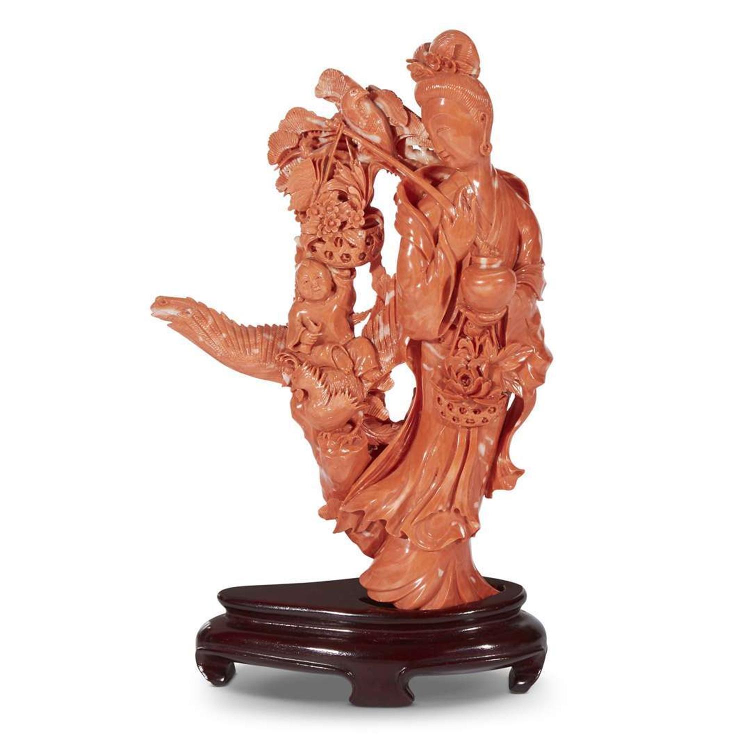 A Japanese carved red coral figure of an Immortal with basket of flowers and a boy on Ho-o bird