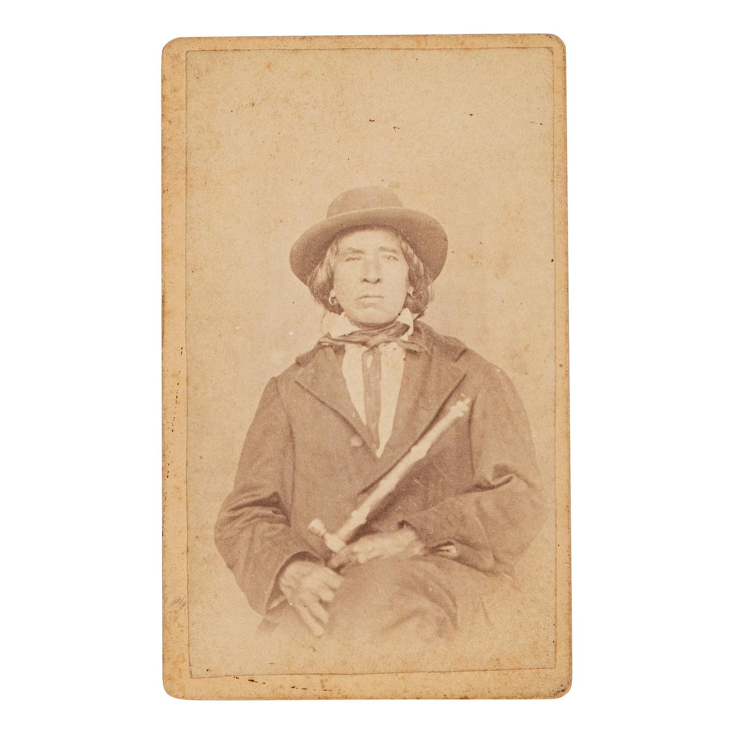 [NATIVE AMERICANS]. CDV of Native American identified as Osage Chief John Red Corn with treaty tomahawk. N.p.: n.p., 1889.